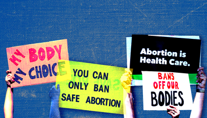 Pro-choice abortion protest signs appear in front of blue background